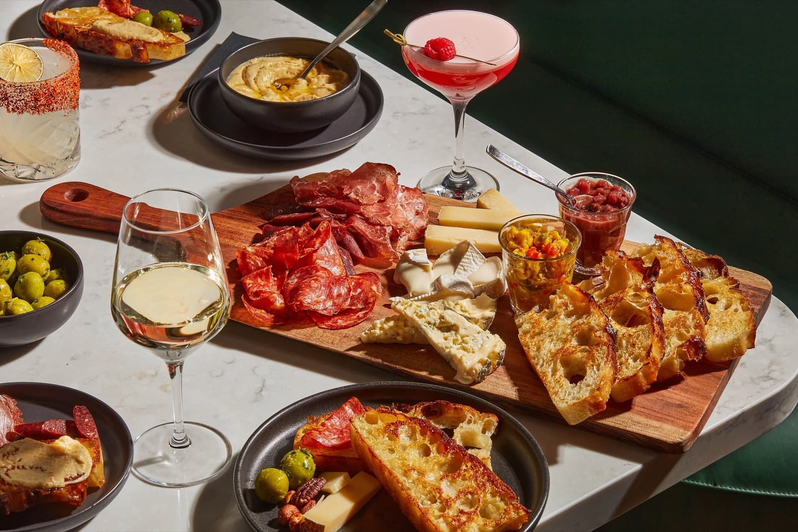An In Good Spirits event spread: charcuterie board, focaccia and cocktails